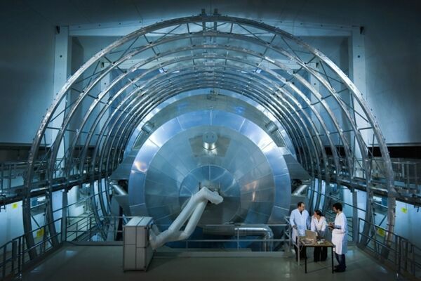 3Q: Scientists shave estimate of neutrino’s mass in half