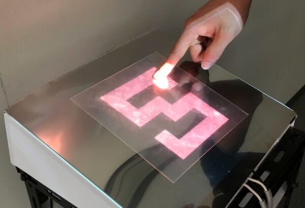 Novel tactile display using computer-controlled surface adhesion