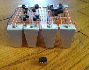 The Famous NE555 Timer-IC, Original and a Bit Larger